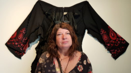 Marion Conrow at the front of the dress she was wearing on the day of her car accident, cut into by the paramedics